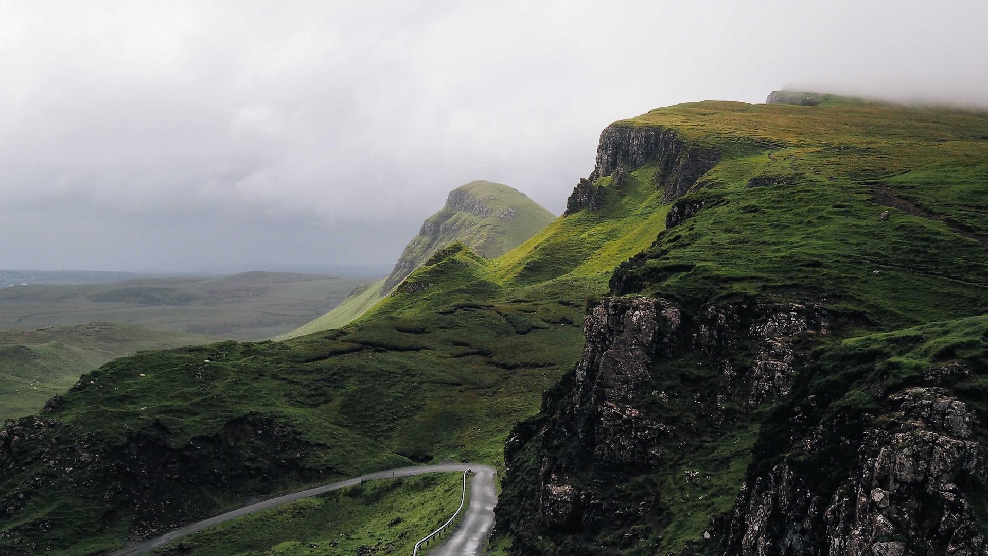 A bright open road winding through green countryside toward the horizon